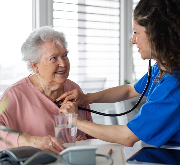 A nurse visiting patient in nursing home.